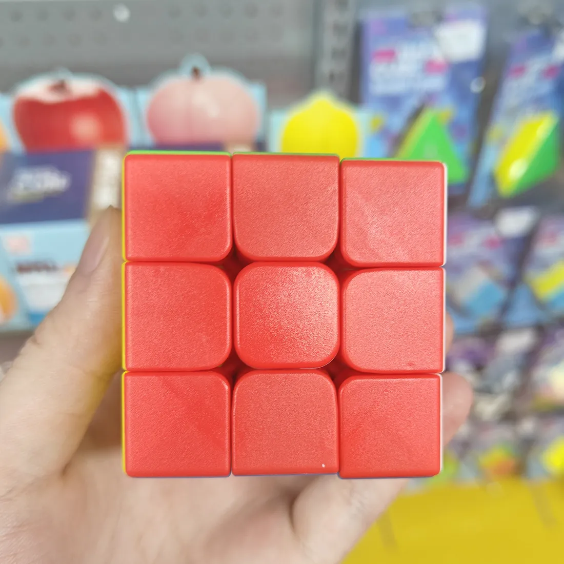 Red side of the stickerless 3×3 speed cube, held in a hand